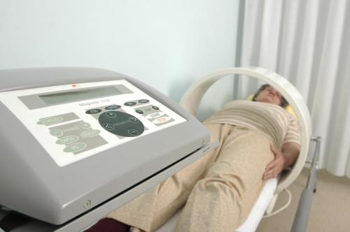 a person laying in a hospital bed with a machine at SeaPark Hotel Wellness & Spa in Kołobrzeg