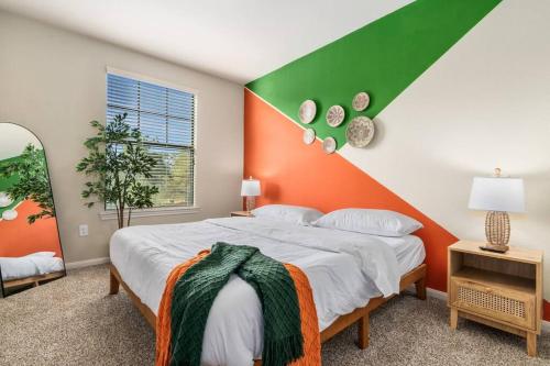 a bedroom with a bed with an orange and green headboard at Modish King Bed w/ Pool & Gym in Houston