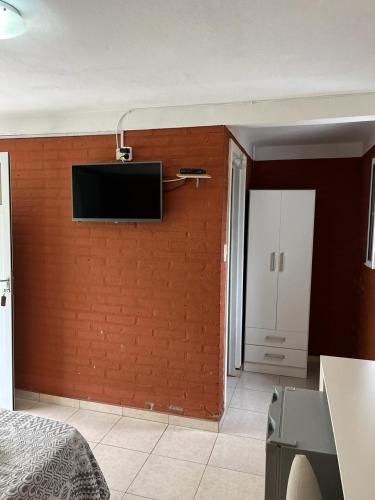 a room with a wall with a television on it at Hotel Aimara in Mina Clavero