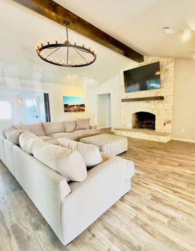 a living room with a white couch and a fireplace at West Texas Rendezvous in Fort Stockton