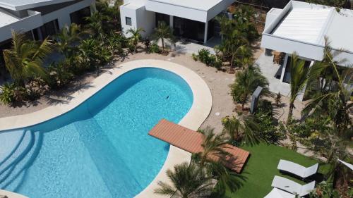 an overhead view of a swimming pool at a resort at One Life Villas in Playa Avellana