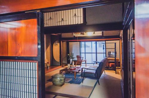 a room with a living room with a table and chairs at A310to 河崎浪漫館 in Sado