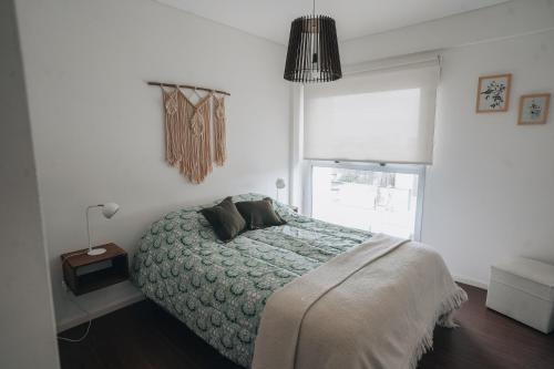 a bedroom with a bed and a window at MI LUGAR * CHIVILCOY in Chivilcoy