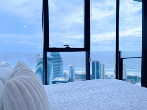 a bedroom with a bed and a view of the city at Magnificent Full Ocean View at Casino Free Parking in Gold Coast