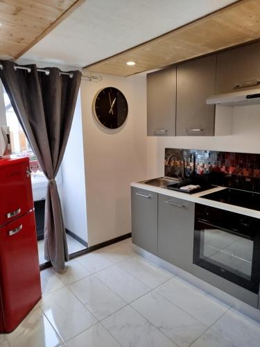 une cuisine avec une horloge murale dans l'établissement Les Souvenirs d'Alsace, à Colmar