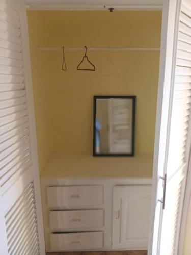 a closet with a mirror and a dresser at Hotel V. Maria in Eslabón