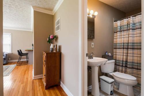 a bathroom with a toilet and a sink at Colonial Village Retreat 2BR in New Albany