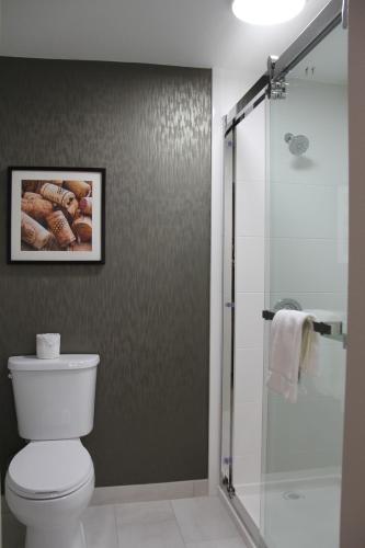a bathroom with a toilet and a glass shower at La Quinta Inn & Suites by Wyndham Yakima Downtown in Yakima