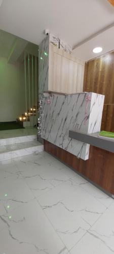 a lobby with a stone wall and a bench at HYTON GRAND in Urapakkam