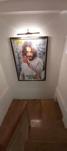 a picture of a man hanging on a wall at HYTON GRAND in Urapakkam