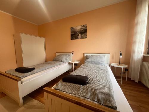 two twin beds in a room with at Simplex Apartments An Der Dreisam in Freiburg im Breisgau