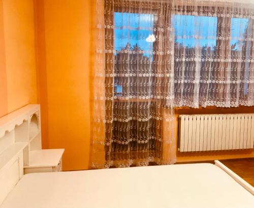 um quarto com uma cama e uma janela em Hostel Odlot Ławica pokoje na wyłączność em Poznań