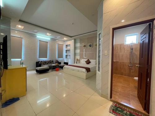 a large room with a bed and a bathroom at Hồng Nhung Hotel Kiên Giang in Rach Gia