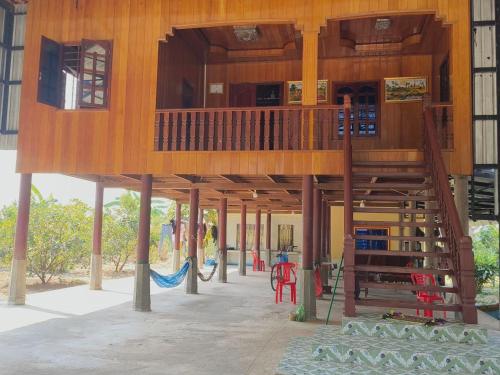 a tree house with a staircase in a playground at Melop Koki Homestay 7 in Krong Kracheh