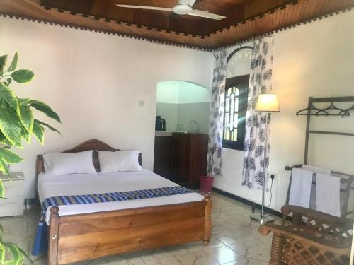 a bedroom with a bed and a mirror at Kingz and Queenz - Negombo in Negombo