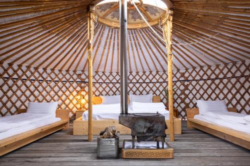 a room with two beds and a piano in a yurt at Yeruu lodge in Jargalant