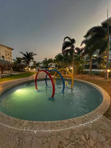 a pool of water in a park at night at Escapada frente al mar, Piscinas y los Mejores Atardeceres -Playa Caracol- in El Quindio
