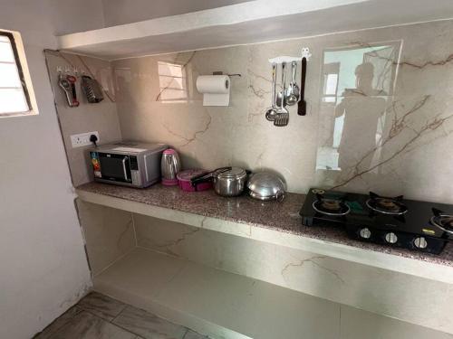 a kitchen with a counter top with a microwave at Authentic Indian Culture in Panchkula