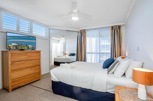 a bedroom with a large bed and a television at Oceanview Delight in Gold Coast