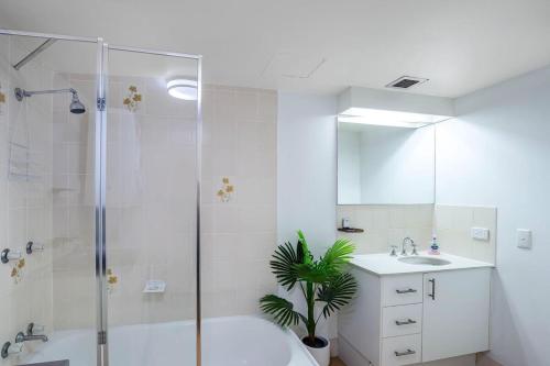 a bathroom with a shower and a toilet and a sink at Oceanview Delight in Gold Coast
