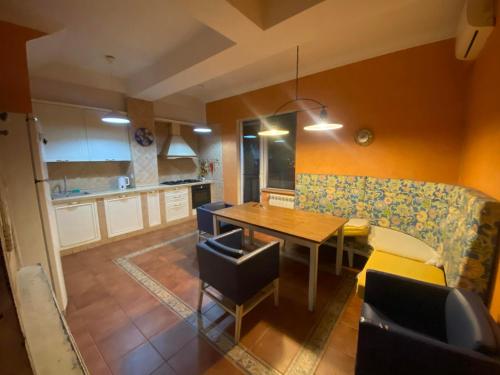 a kitchen and dining room with a table and a couch at Apartment Tbilisi View in Tbilisi City