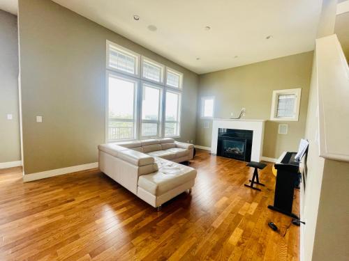 a living room with a couch and a fireplace at Guest room in Langford in Victoria