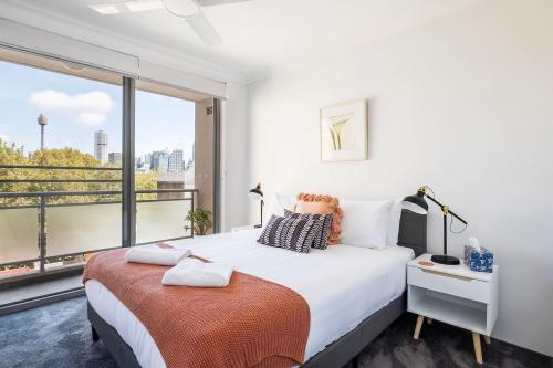 a bedroom with a large bed and a large window at The Earl - Potts Point Paradise with Sydney Views in Sydney