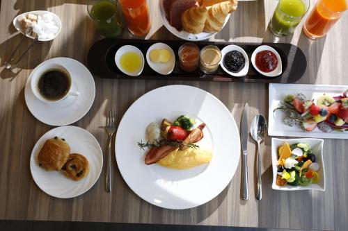 a table with plates of food and a cup of coffee at Palace Hotel Omiya in Saitama