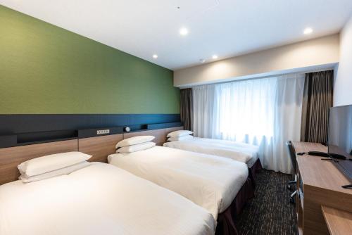 Postel nebo postele na pokoji v ubytování Hotel Kazusaya