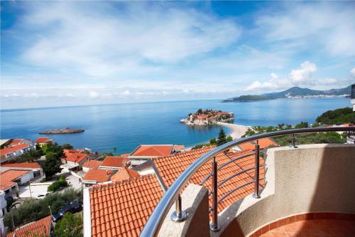 a view of the ocean from a balcony at Apartments Baron in Sveti Stefan