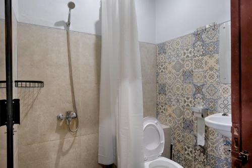 La salle de bains est pourvue d'une douche, de toilettes et d'un lavabo. dans l'établissement HUBS Hostel Yogyakarta, à Yogyakarta