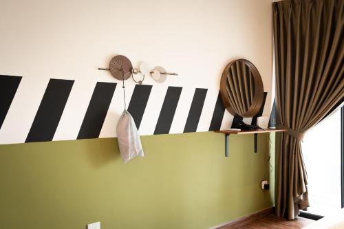 a room with black and white stripes on the wall at K Avenue by Pinstay in Donggongon