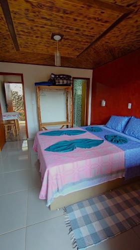 a bedroom with a large bed in a room at Residência Da Família Binitz in Visconde De Maua