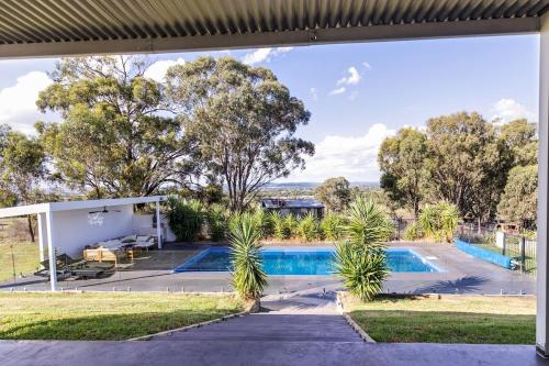 an external view of a house with a swimming pool at The Albens - Countryside Chic amongst the Hills in Mudgee