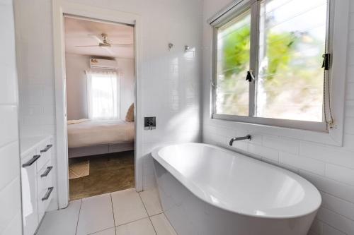 a white bathroom with a tub and a window at The Albens - Countryside Chic amongst the Hills in Mudgee