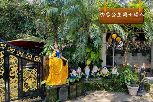 a woman in a yellow dress standing next to a group of children at Xin Yuan My Dream Castle in Dongshan