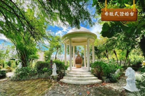 a gazebo in a garden with a vase at Xin Yuan My Dream Castle in Dongshan