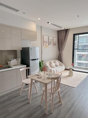 a kitchen and living room with a table and a couch at Bunny Bliss-Service Apartment in Hanoi