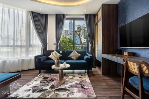 a living room with a couch and a tv at KunKin Garden Aparthotel in Ho Chi Minh City