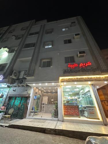 a store front of a building at night at Al Badeel Hotel in Al Madinah