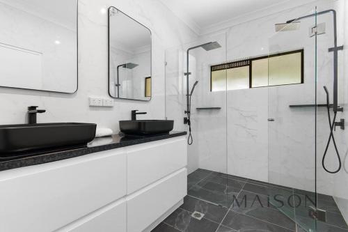 a bathroom with a black sink and a shower at Family Getaway in Salt Ash in Salt Ash