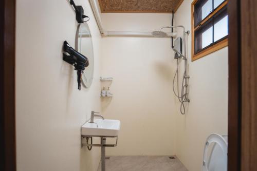 a bathroom with a sink and a phone on the wall at Phu Naphat Resort in Tha Kradan