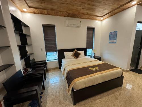 sypialnia z dużym łóżkiem i biurkiem w obiekcie Nhà nghỉ Giang Sơn w mieście Bac Ha