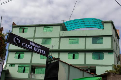 a building with a sign in front of it at Casa Hotel Místico in Ayacucho