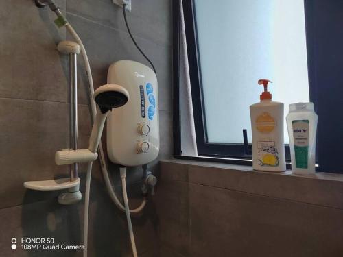 a bathroom with a hair dryer and a window at H20 residence studio high floor in Petaling Jaya