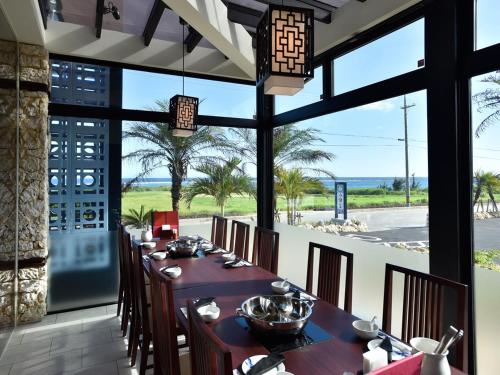a dining room with a long table and chairs at Hotel Shigira Mirage Beach Front in Miyako Island