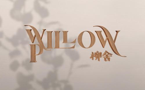a wooden sign that reads willow on a wall at Willow Pillow Guest House & Poshtel in Chumphon