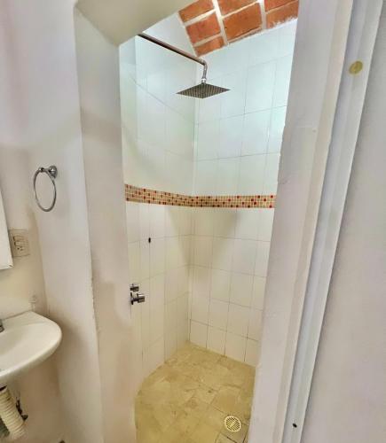 a bathroom with a shower with a toilet and a sink at Casa Baluana vive Sayulita a un paso de todo in Sayulita