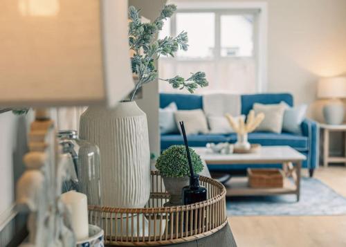 a living room with a blue couch and a table at Rockfield in Kinvara