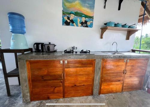 a kitchen with a sink and a counter top at Siargao Wakepark in General Luna
